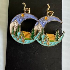gold-tone enamel crescent moon earrings with cabin and forest scene